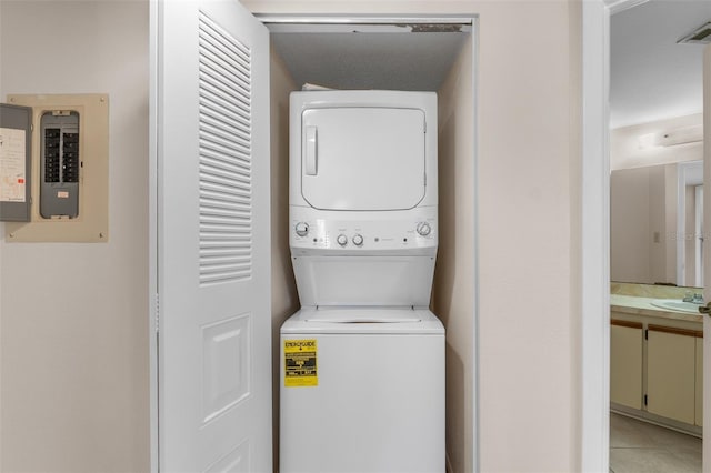 19505 Quesada Ave Unit A204, Port Charlotte, FL 33948 - laundry room with stacked washing maching and dryer, light tile patterned flooring, electric panel, laundry area, and visible vents