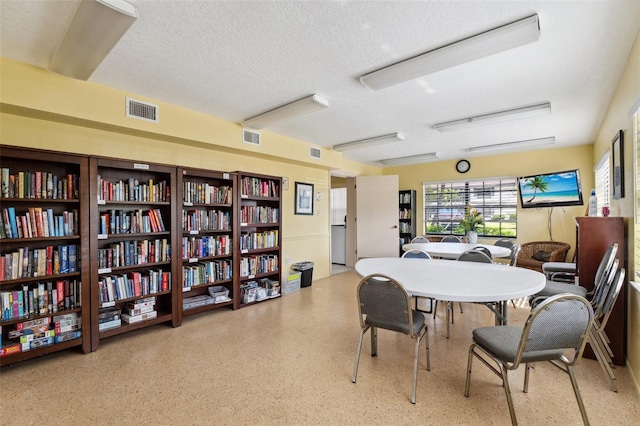 19505 Quesada Ave Unit A204, Port Charlotte, FL 33948 - dining room featuring visible vents, speckled floor, and a textured ceiling
