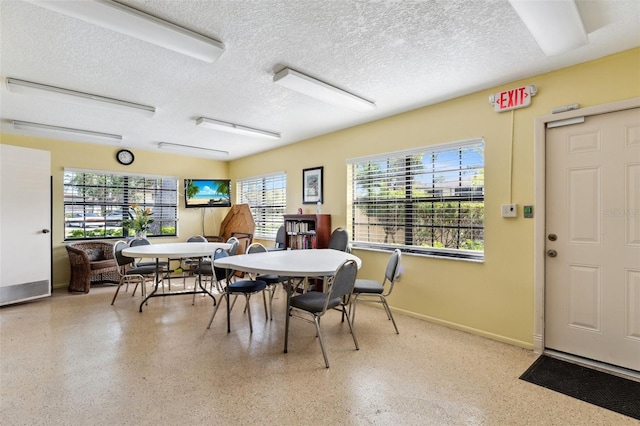 19505 Quesada Ave Unit A204, Port Charlotte, FL 33948 - dining room featuring a textured ceiling, speckled floor, and baseboards