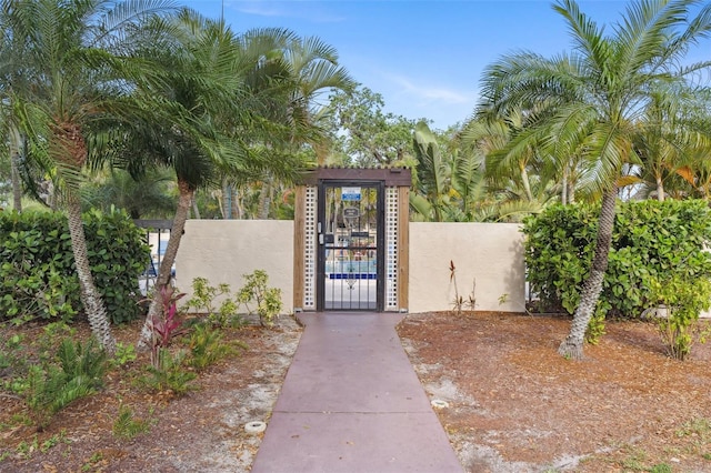 19505 Quesada Ave Unit A204, Port Charlotte, FL 33948 - doorway to property featuring stucco siding, fence, and a gate