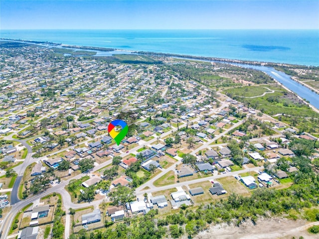 birds eye view of property with a water view and a residential view