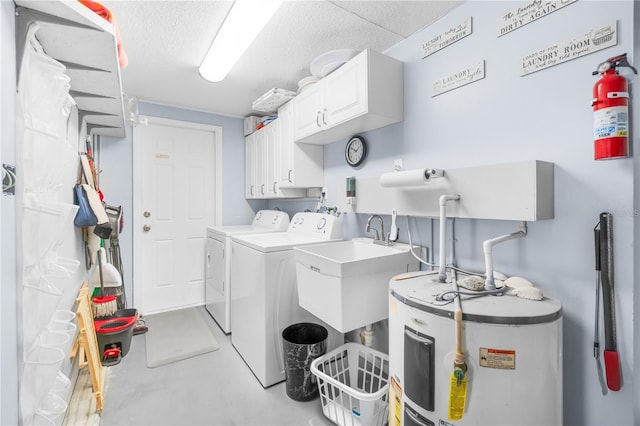 laundry area featuring a textured ceiling, washing machine and clothes dryer, a sink, cabinet space, and water heater