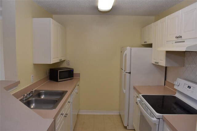 18001 Richmond Place Dr Unit 636, Tampa, FL 33647 - kitchen with a sink, white cabinetry, under cabinet range hood, and white appliances