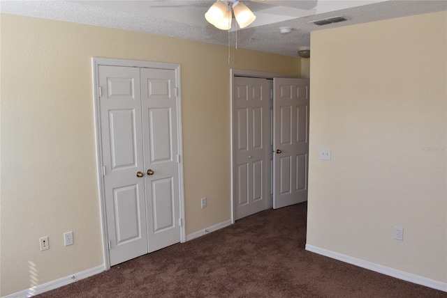 18001 Richmond Place Dr Unit 636, Tampa, FL 33647 - unfurnished bedroom featuring carpet floors, two closets, ceiling fan, baseboards, and visible vents