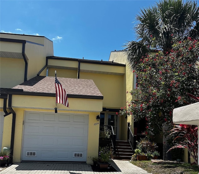 25188 Marion Ave Unit 1004, Punta Gorda, FL 33950 - townhome / multi-family property featuring decorative driveway, a garage, stucco siding, and a shingled roof