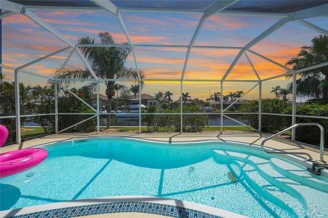 48 Hibiscus Dr, Punta Gorda, FL 33950 - pool at dusk featuring an outdoor pool, a patio, and glass enclosure