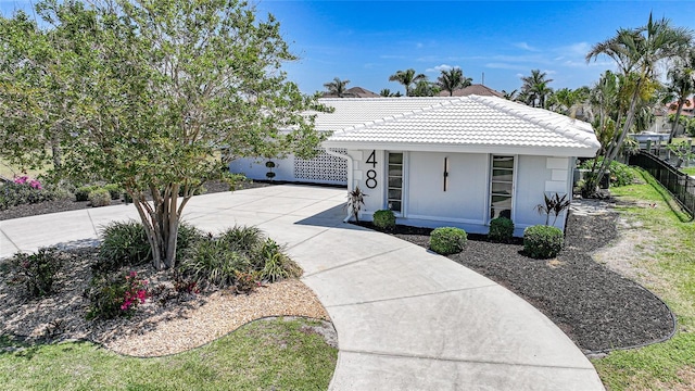 48 Hibiscus Dr, Punta Gorda, FL 33950 - view of front of property featuring concrete driveway, fence, stucco siding, and a tiled roof