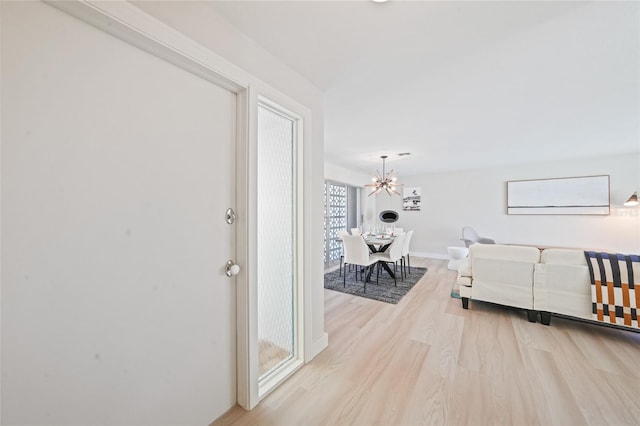 48 Hibiscus Dr, Punta Gorda, FL 33950 - hallway with wood finished floors and an inviting chandelier