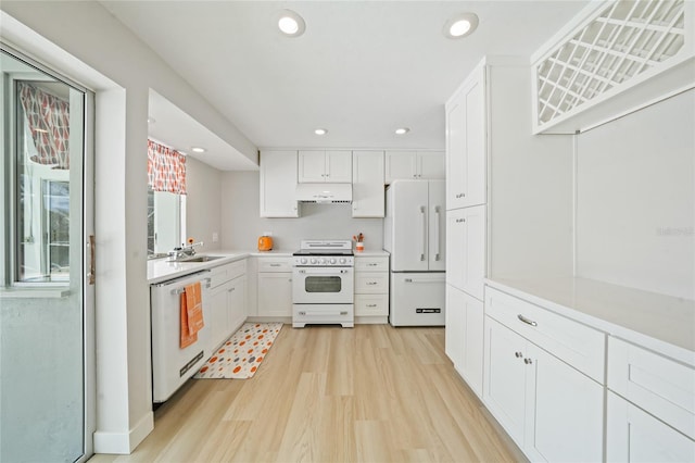 48 Hibiscus Dr, Punta Gorda, FL 33950 - kitchen with light wood-style flooring, a sink, light countertops, under cabinet range hood, and white appliances