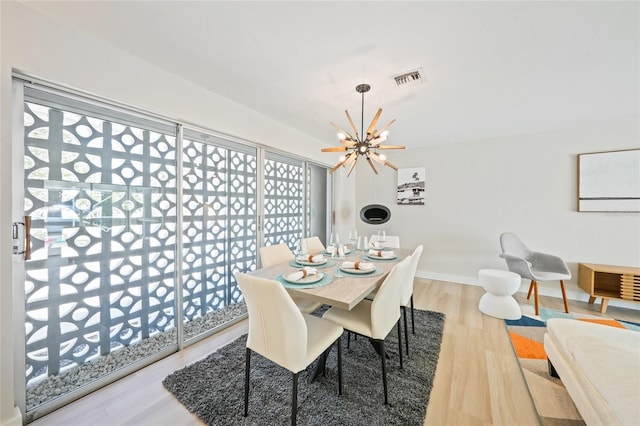 48 Hibiscus Dr, Punta Gorda, FL 33950 - dining area with an inviting chandelier, wood finished floors, visible vents, and baseboards