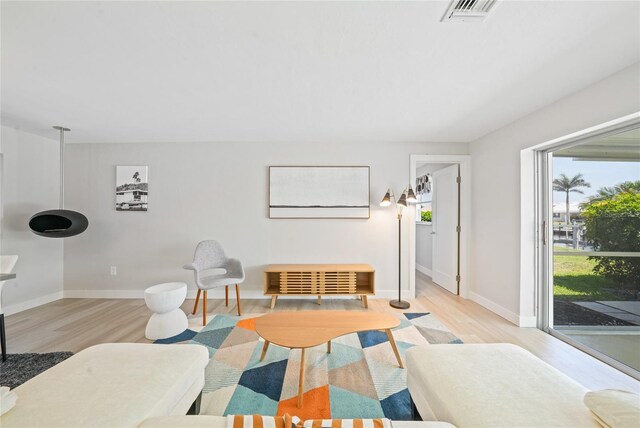 48 Hibiscus Dr, Punta Gorda, FL 33950 - living area featuring visible vents, light wood-style flooring, and baseboards