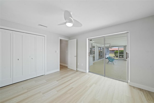 48 Hibiscus Dr, Punta Gorda, FL 33950 - unfurnished bedroom featuring ceiling fan, access to exterior, visible vents, baseboards, and wood finished floors