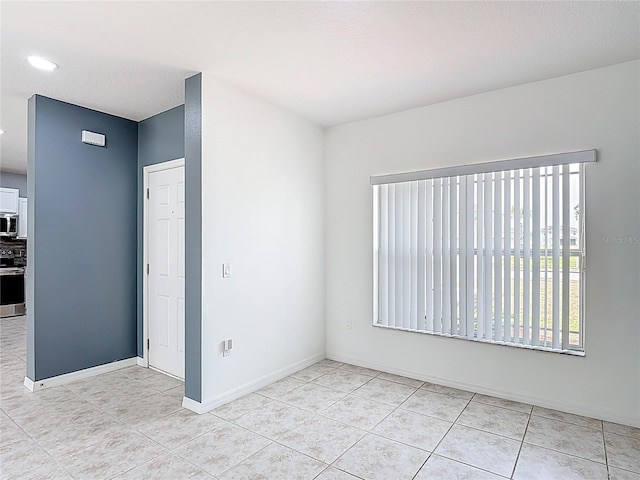 3514 Yacht Club Ct, Kissimmee, FL 34746 - empty room with light tile patterned floors, recessed lighting, and baseboards