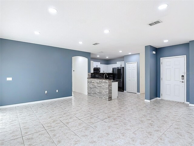 3514 Yacht Club Ct, Kissimmee, FL 34746 - unfurnished living room featuring baseboards, visible vents, and light tile patterned floors