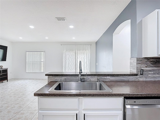 3514 Yacht Club Ct, Kissimmee, FL 34746 - kitchen featuring a sink, visible vents, stainless steel dishwasher, dark countertops, and white cabinets