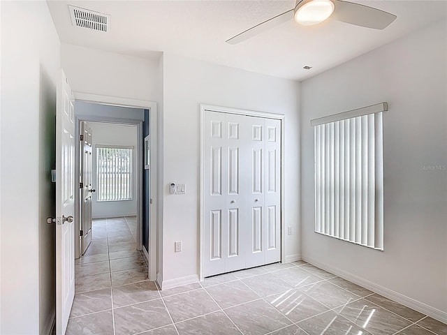 3514 Yacht Club Ct, Kissimmee, FL 34746 - unfurnished bedroom featuring visible vents, a ceiling fan, baseboards, and a closet