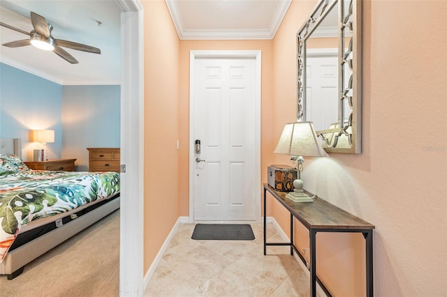 foyer with baseboards, a ceiling fan, tile patterned flooring, and crown molding