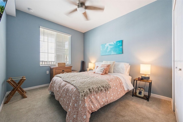 bedroom with ceiling fan, baseboards, and carpet floors