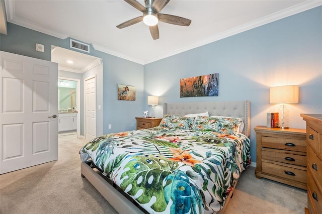 bedroom featuring ensuite bathroom, carpet flooring, baseboards, visible vents, and crown molding