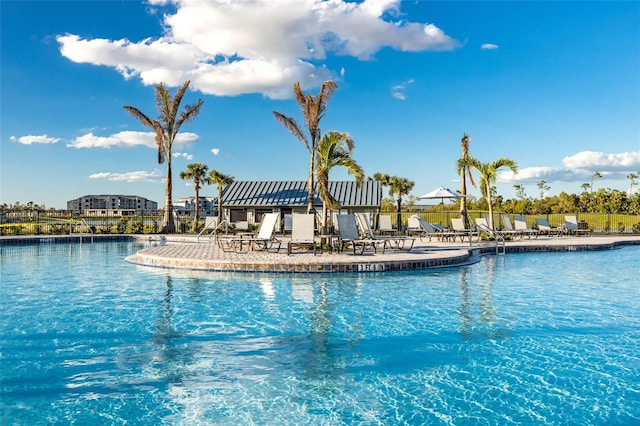 community pool featuring a patio and fence
