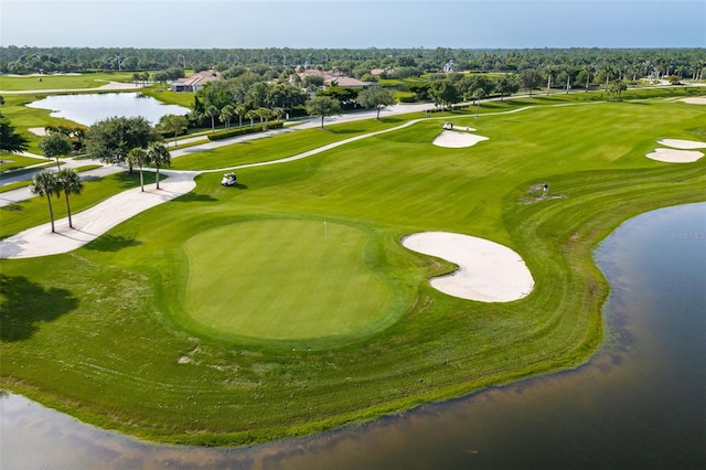 aerial view with golf course view and a water view