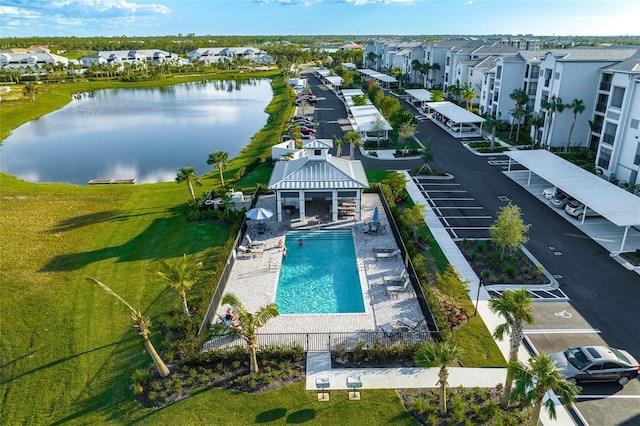 drone / aerial view featuring a residential view and a water view