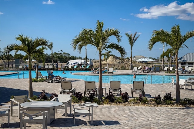 pool featuring fence and a patio area