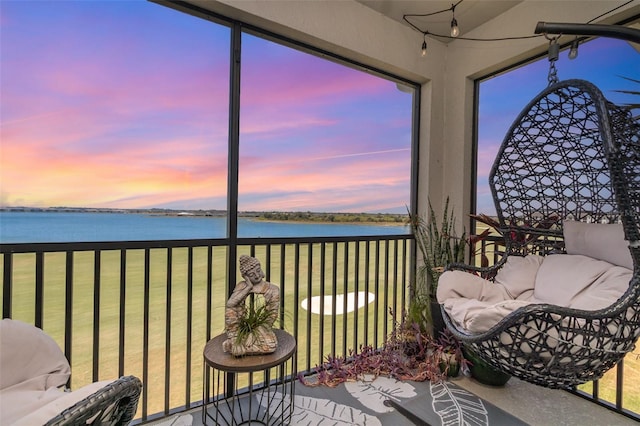sunroom / solarium with a water view