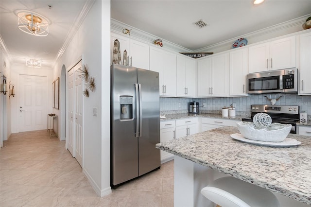 kitchen featuring visible vents, white cabinets, tasteful backsplash, and stainless steel appliances