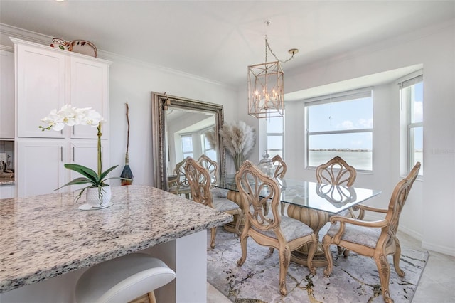 dining room featuring crown molding, baseboards, and a chandelier