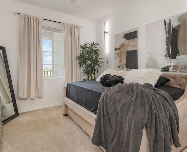 carpeted bedroom featuring baseboards