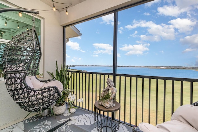 sunroom / solarium with a water view