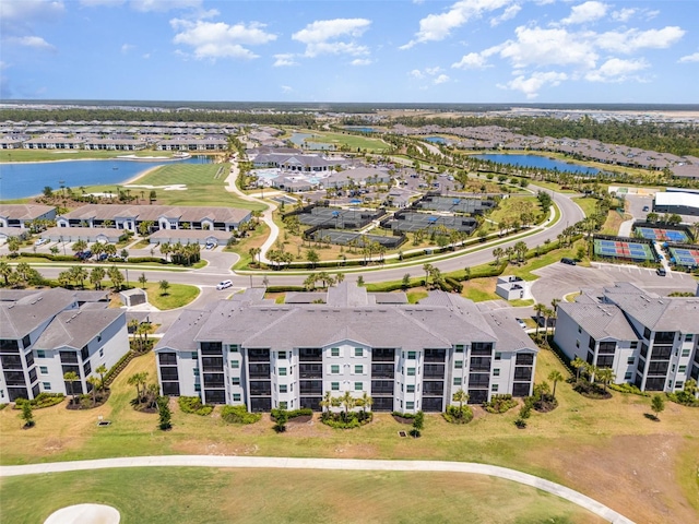 bird's eye view with a water view, view of golf course, and a residential view