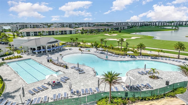 pool featuring a patio, a water view, and view of golf course