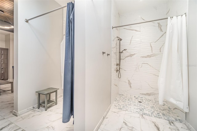 bathroom with marble finish floor and curtained shower