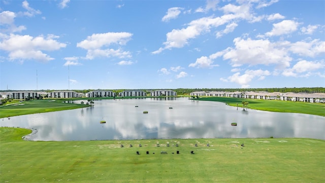 view of home's community featuring a lawn, view of golf course, and a water view