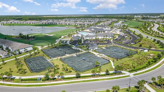 bird's eye view with a water view, view of golf course, and a residential view