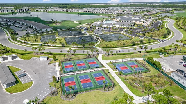 birds eye view of property with a residential view, view of golf course, and a water view