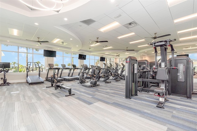 exercise room featuring a ceiling fan, visible vents, and carpet