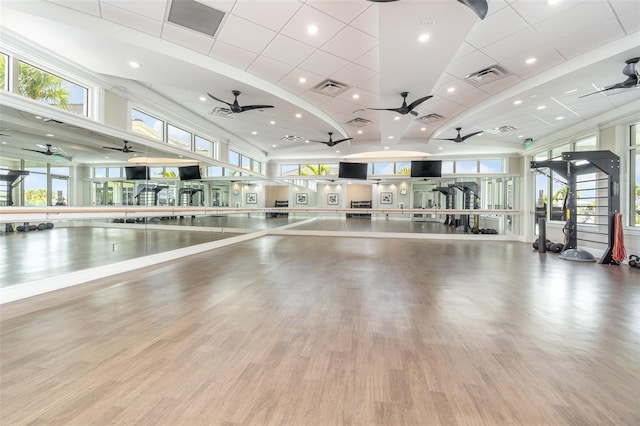 exercise room with ceiling fan, wood finished floors, and visible vents