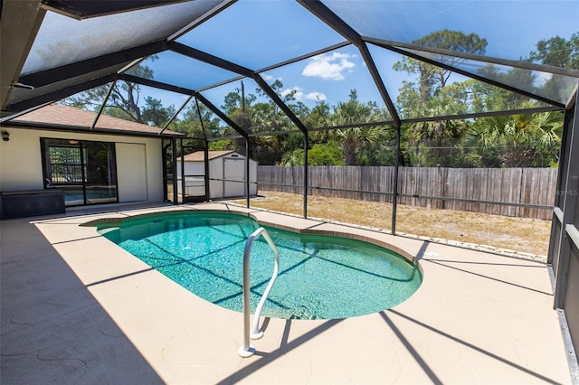 view of swimming pool featuring a storage shed, a patio, a fenced in pool, and a fenced backyard