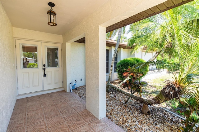 doorway to property with fence and stucco siding