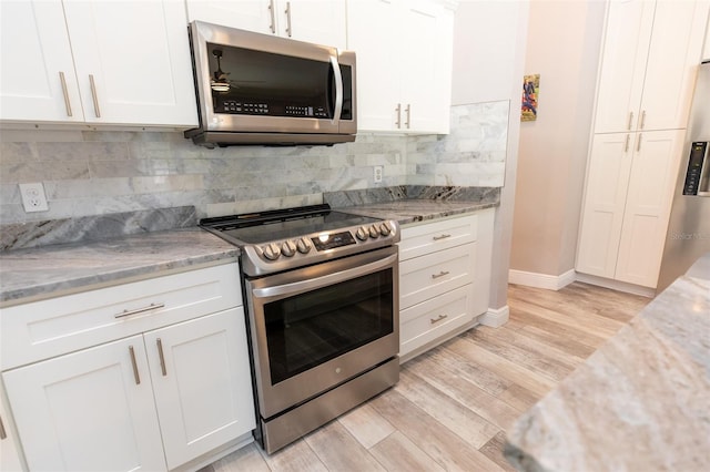 kitchen featuring light wood-style flooring, white cabinets, and appliances with stainless steel finishes