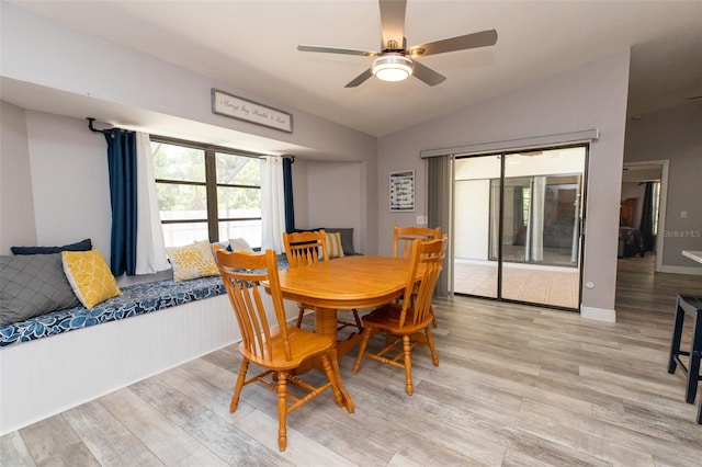 dining room featuring wood finished floors, ceiling fan, and vaulted ceiling