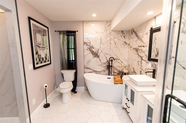 bathroom with recessed lighting, vanity, toilet, tile patterned flooring, and a soaking tub