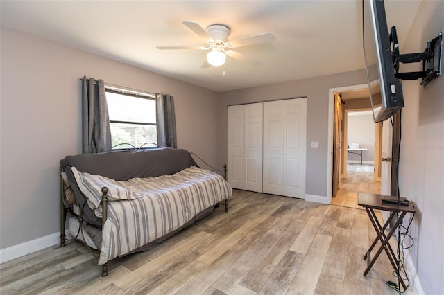 interior space featuring baseboards, ceiling fan, and light wood finished floors