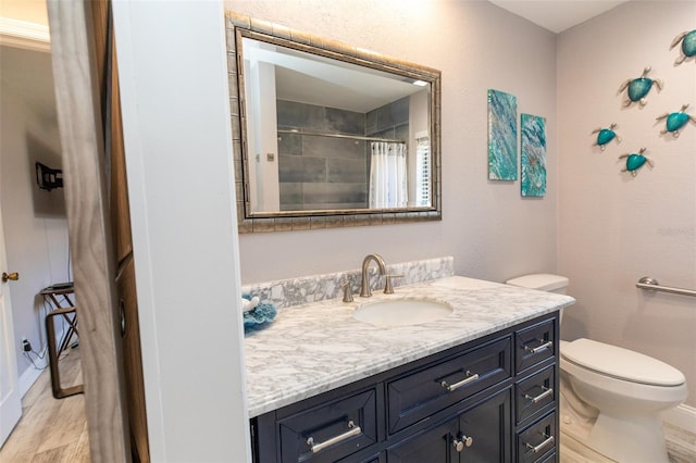 full bathroom featuring toilet, curtained shower, wood finished floors, and vanity