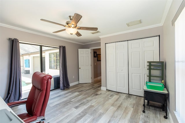 office space with baseboards, light wood-type flooring, ceiling fan, and crown molding