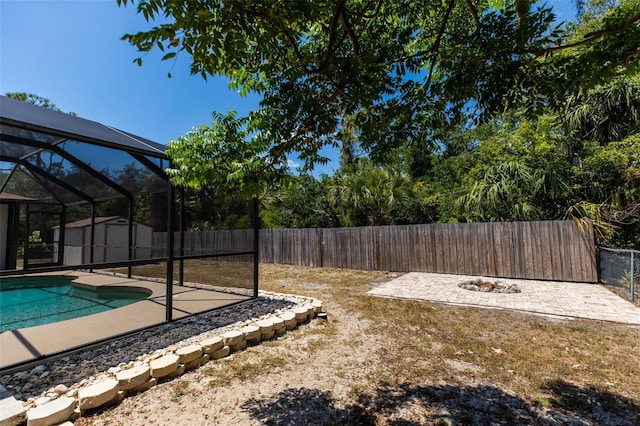 view of yard with a patio, an outbuilding, a fenced in pool, a fenced backyard, and a storage shed