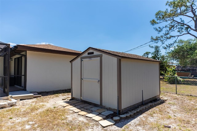 view of shed with fence